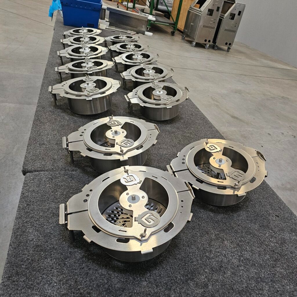 Set of precision machined stainless steel plates laid out for a customer assembly